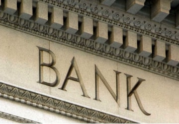 A close up of the word bank on top of a building