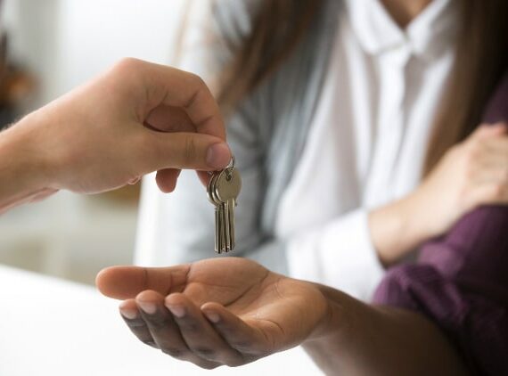 A person is handing over the keys to another person.